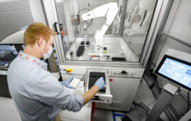 lab technician working by ABB robot.