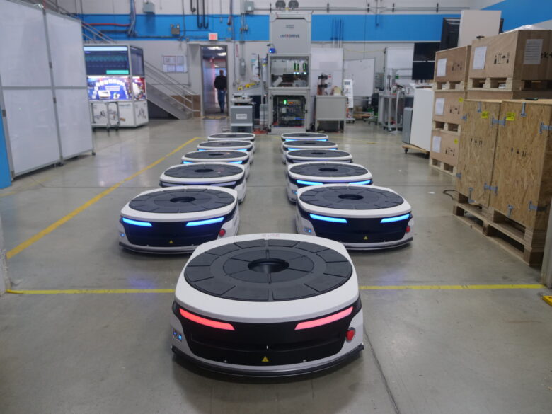A fleet of Bosch Rexroth autonomous mobile robots (AMRs) in an warehouse.